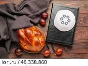 Traditional challah bread with Jewish cap and Tanakh on wooden background. Shabbat Shalom. Стоковое фото, фотограф Pixel_shot / Фотобанк Лори