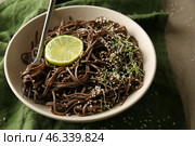 Plate with tasty soba noodles on grey table. Стоковое фото, фотограф Pixel_shot / Фотобанк Лори