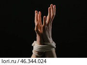 Female hostage with tied hands on dark background, closeup. Стоковое фото, фотограф Pixel_shot / Фотобанк Лори