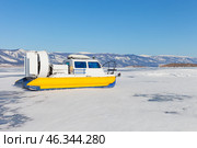 Traveling on ice of frozen Baikal Lake on hovercraft Khivus on sunny winter day. Winter landscape of Small Sea. Natural background. Adventures and outdoor recreation. Empty space for text. Стоковое фото, фотограф Виктория Катьянова / Фотобанк Лори