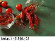 Overturned glass jar with dried chili peppers on table. Стоковое фото, фотограф Pixel_shot / Фотобанк Лори