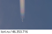 Airplane with colorful contrails in blue sky. Стоковое видео, видеограф Игорь Жоров / Фотобанк Лори