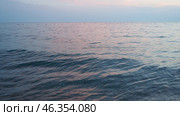 Observe tranquil beauty as sun sets on horizon, casting soft hues across ocean. Gentle waves ripple peacefully, creating a serene atmosphere that invites reflection. Mediterranean Adriatic Sea. Стоковое видео, видеограф Юлия Петровская / Фотобанк Лори