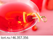 Glass of tasty cosmopolitan cocktail on color wooden background, closeup. Стоковое фото, фотограф Pixel_shot / Фотобанк Лори