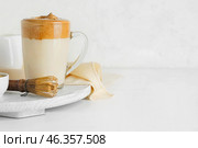 Glass cup of tasty dalgona hojicha latte and chasen on light background. Стоковое фото, фотограф Pixel_shot / Фотобанк Лори