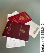 Russian and Colombian biometric passports with a couple of tickets. Стоковое фото, фотограф Виктор Ветошкин / Фотобанк Лори