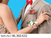 Young girl with corsage and her prom date on blue background, closeup. Стоковое фото, фотограф Pixel_shot / Фотобанк Лори