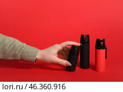 Woman with pepper sprays on red background. Стоковое фото, фотограф Pixel_shot / Фотобанк Лори