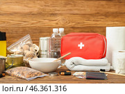 Necessities for emergency bag on wooden table. Стоковое фото, фотограф Pixel_shot / Фотобанк Лори
