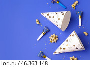 Party hats and whistles on dark blue background. Стоковое фото, фотограф Pixel_shot / Фотобанк Лори