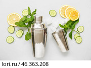 Cocktail shaker and jigger with mojito ingredients on light background. Стоковое фото, фотограф Pixel_shot / Фотобанк Лори