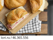 Delicious kaiser rolls with ham and cheese on table. Стоковое фото, фотограф Pixel_shot / Фотобанк Лори