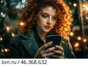 A businesswoman with curly red hair and freckles. She's wearing a coat. In the hands of a smartphone. A small business entrepreneur looks at her mobile phone. Стоковое AI-изображение, AI-художник Photojuli / Фотобанк Лори