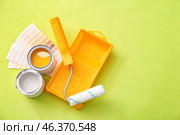 Paint cans and tray with roller on color background. Стоковое фото, фотограф Pixel_shot / Фотобанк Лори