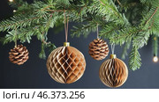 Honeycomb Paper Ornaments Hanging on a Christmas Tree. Paper Christmas Handmade foldable decor. Winter Creativity Crafts. Trendy Eco DIY. Modern Decoration. Boho Design. Structural 3d Origami Toy. Стоковое AI-видео, аниматор Марина Демидюк / Фотобанк Лори