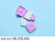 Tampons storage boxes on blue background, top view. Стоковое фото, фотограф Pixel_shot / Фотобанк Лори