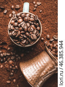 Cup with coffee beans and jezve on powder. Стоковое фото, фотограф Pixel_shot / Фотобанк Лори
