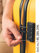 Male thief trying to open stolen suitcase, closeup. Стоковое фото, фотограф Pixel_shot / Фотобанк Лори