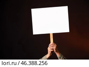 Protesting woman with placard on dark background. Стоковое фото, фотограф Pixel_shot / Фотобанк Лори