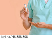 Doctor with lancet pen on color background. Diabetes concept. Стоковое фото, фотограф Pixel_shot / Фотобанк Лори