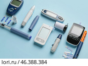Glucometers with lancet pens, test strips and syringes on color background. Diabetes concept. Стоковое фото, фотограф Pixel_shot / Фотобанк Лори