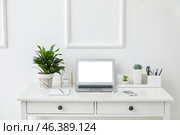 Stylish workplace with laptop near white wall. Стоковое фото, фотограф Pixel_shot / Фотобанк Лори
