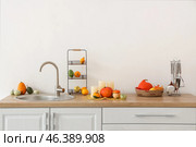 Counters with sink, candles and Halloween pumpkins in light kitchen. Стоковое фото, фотограф Pixel_shot / Фотобанк Лори