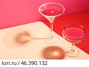 Glasses of Cosmopolitan cocktail on colorful background. Стоковое фото, фотограф Pixel_shot / Фотобанк Лори