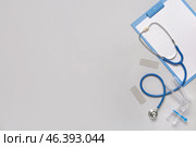 Clipboard with stethoscope and gynecological speculum on grey background. Стоковое фото, фотограф Pixel_shot / Фотобанк Лори