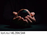 Fortune teller with crystal ball on dark background. Стоковое фото, фотограф Pixel_shot / Фотобанк Лори