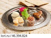 Passover Seder plate with traditional food on table. Стоковое фото, фотограф Pixel_shot / Фотобанк Лори