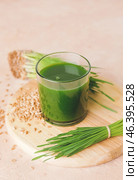 Glass with fresh wheatgrass juice on light background. Стоковое фото, фотограф Pixel_shot / Фотобанк Лори