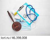 Judge gavel, pills, thermometer, masks and stethoscope on white background. Concept of health care reform. Стоковое фото, фотограф Pixel_shot / Фотобанк Лори