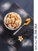 Ramekin with tasty vanilla ice cream on dark background. Стоковое фото, фотограф Pixel_shot / Фотобанк Лори