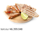 Board with tasty quesadillas and lime on white background. Стоковое фото, фотограф Pixel_shot / Фотобанк Лори