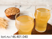 Glasses of fresh kvass on light background. Стоковое фото, фотограф Pixel_shot / Фотобанк Лори