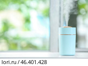 Modern humidifier on table in room. Стоковое фото, фотограф Pixel_shot / Фотобанк Лори