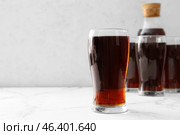 Glasses of fresh kvass on light background. Стоковое фото, фотограф Pixel_shot / Фотобанк Лори