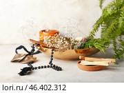 Palo Santo, beads, karatalas and incense on light background. Стоковое фото, фотограф Pixel_shot / Фотобанк Лори