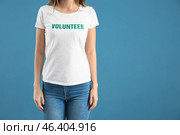 Young female volunteer on color background. Стоковое фото, фотограф Pixel_shot / Фотобанк Лори