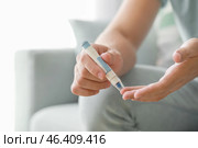 Diabetic man taking blood sample with lancet pen at home, closeup. Стоковое фото, фотограф Pixel_shot / Фотобанк Лори