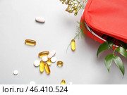 First aid kit with herbs and pills on light background. Стоковое фото, фотограф Pixel_shot / Фотобанк Лори