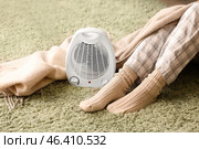 Electric fan heater and woman in warm socks at home. Стоковое фото, фотограф Pixel_shot / Фотобанк Лори