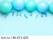 Blue balloons, ribbons, party whistles and serpentine on color background. Стоковое фото, фотограф Pixel_shot / Фотобанк Лори