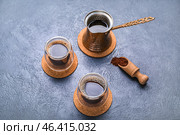 Drink coasters with glasses of coffee and jezve on blue table. Стоковое фото, фотограф Pixel_shot / Фотобанк Лори