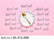 Saucer, spoon and text DON'T EAT on color background. Anorexia concept. Стоковое фото, фотограф Pixel_shot / Фотобанк Лори