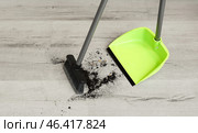 Sweeping of rubbish with dustpan and broom on floor. Стоковое фото, фотограф Pixel_shot / Фотобанк Лори