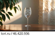 Elegant etched glass on a wooden table near a window with natural light creating a soft ambiance in a cozy room. Стоковое AI-изображение, AI-художник Сергей Толмачёв / Фотобанк Лори