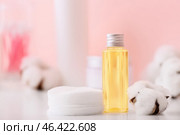 Bottle of cottonseed oil with cosmetic pads on table. Стоковое фото, фотограф Pixel_shot / Фотобанк Лори