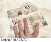 Kirov, Russia - January 19, 2025: Hand holding receipts on a table in a casual setting, documenting recent purchases and transactions. Редакционное фото, фотограф Кривошеина Елена Леонидовна / Фотобанк Лори